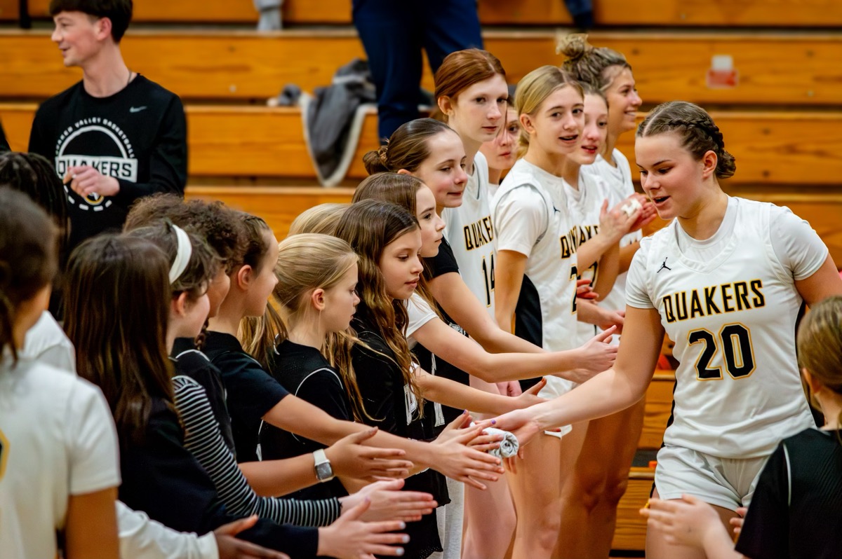 QV players high-fiving young fans during pregame introductions