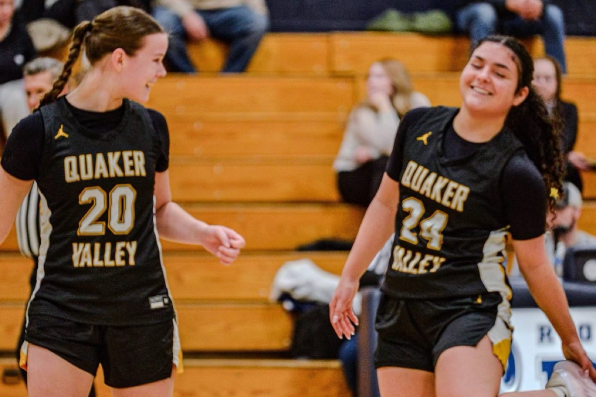 QV players #20 and #24 celebrating during a game
