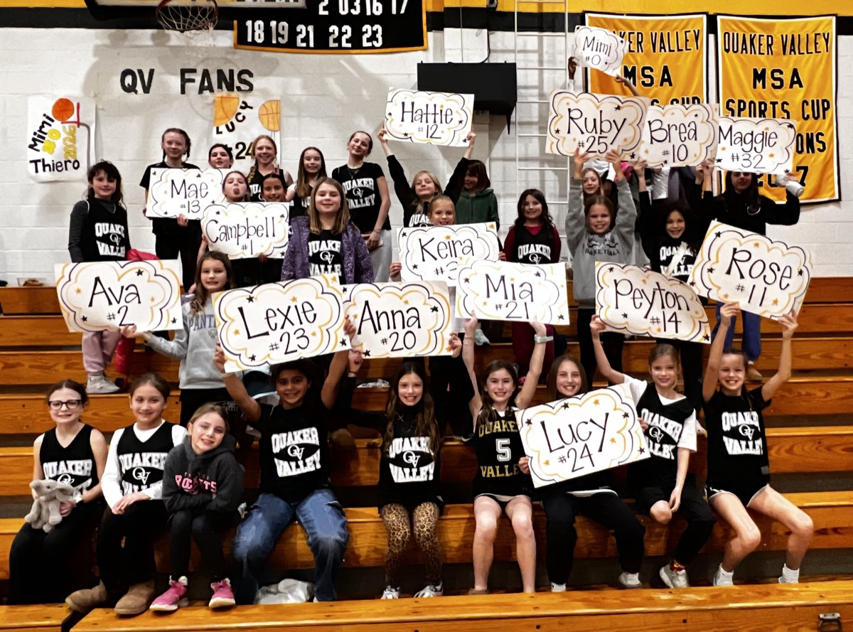 Young QV fans in the stands holding signs with player names